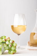 Glass Wine With Green Grapes Close Up